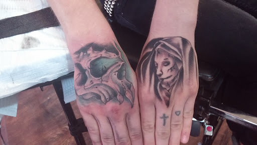 Explore red cardinal tattoo ideas, creative tattoo ideas in Quincy, available at Threshold Of Pain Tattoo Shop