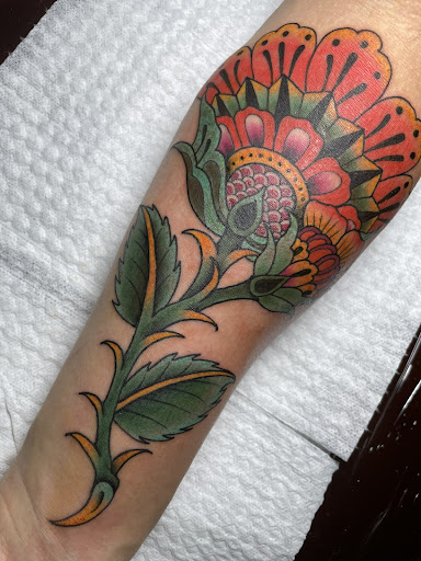 Explore flower leg tattoo ideas, creative tattoo ideas in Newburgh, available at Millennium Tattoo