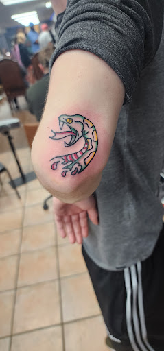 Explore small snake tattoo ideas, creative tattoo ideas in Abilene, available at Sacred Art