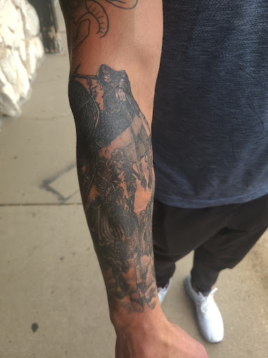 Explore black men tattoo ideas, creative tattoo ideas in Omaha, available at LeVeL UP Tattoo
