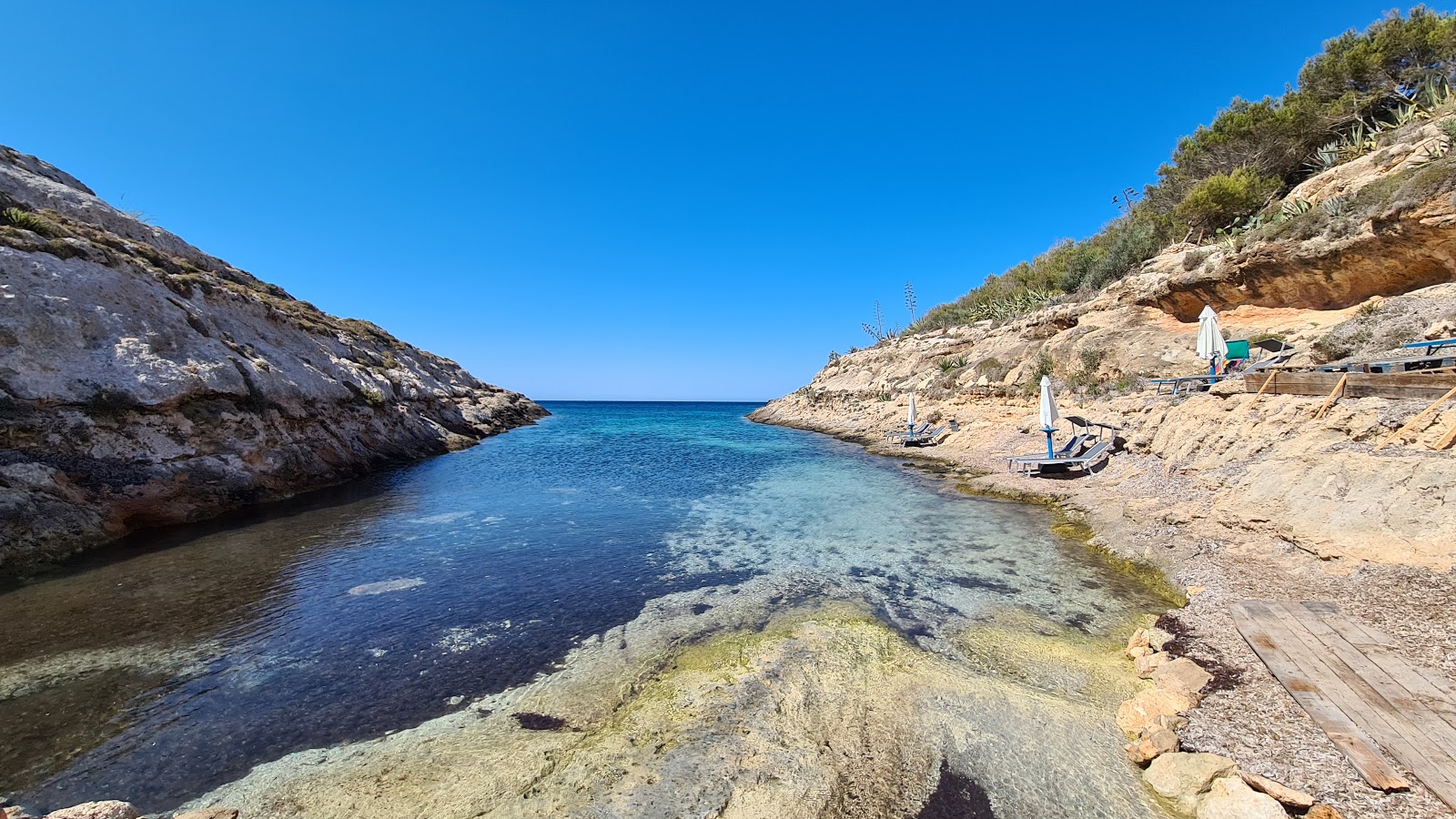 Photo of Cala Greca with turquoise pure water surface