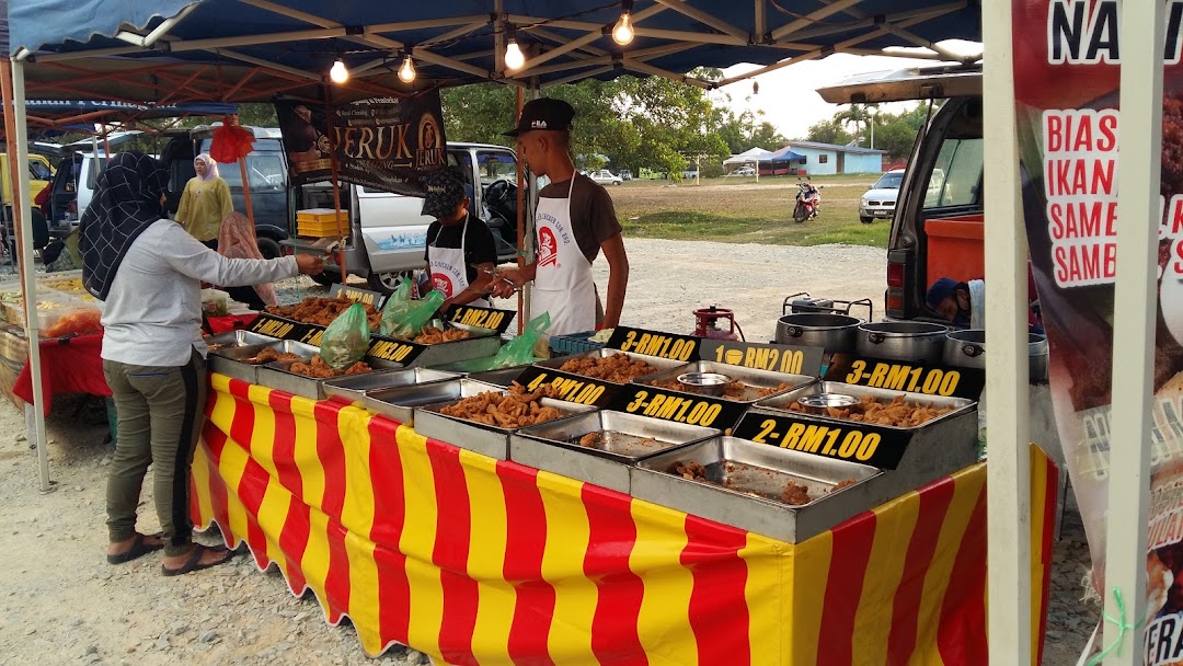 Prepared dishes at a red-and-yellow stall — Pasar Malam Chukai gallery