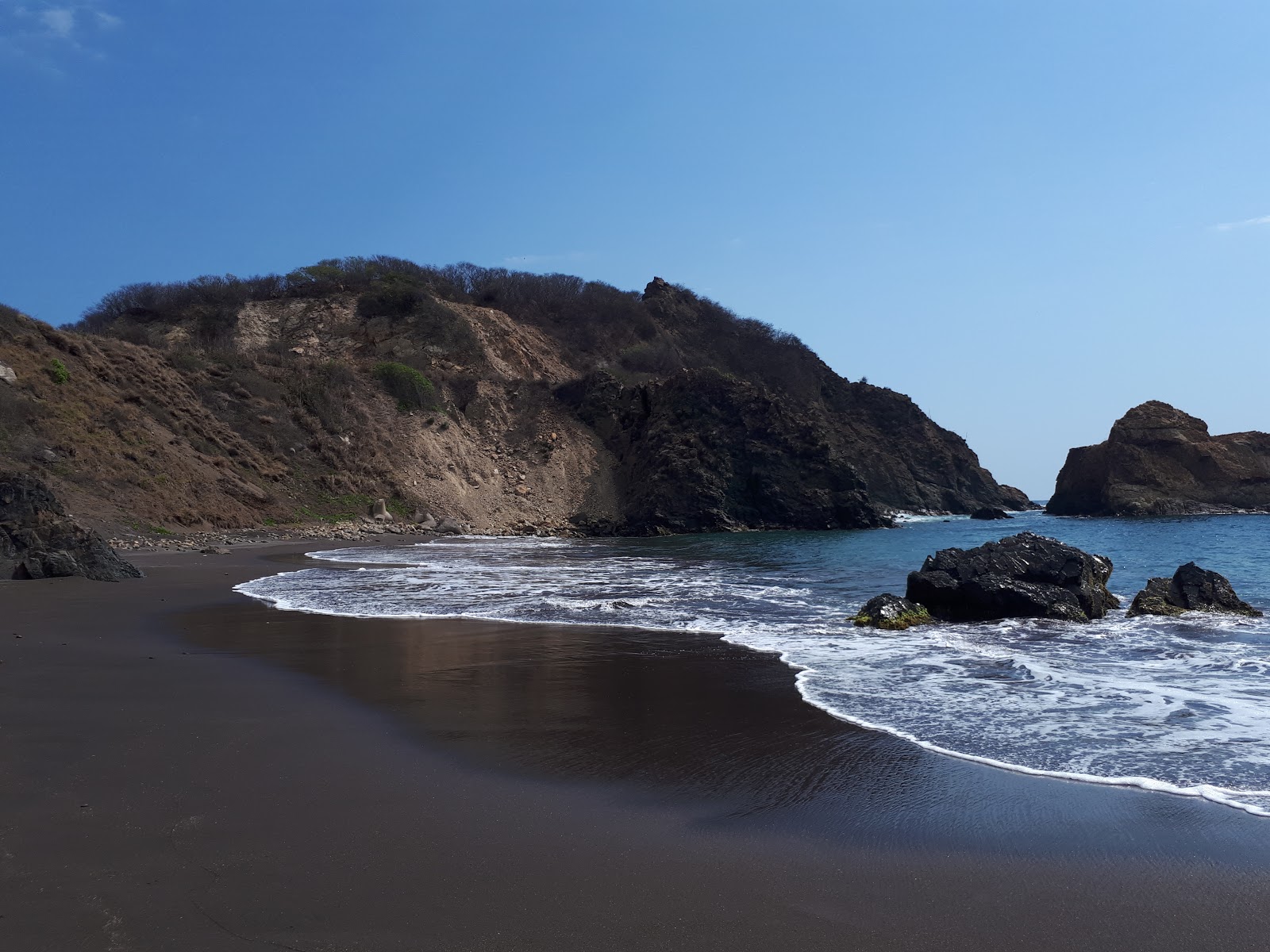 Foto van Playa del Viejo met bruin zand oppervlakte