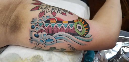 Explore indian feather tattoo ideas, creative tattoo ideas in Asheville, available at Serpent & the Rainbow Tattoo