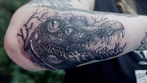 Explore curious george tattoo ideas, creative tattoo ideas in Savannah, available at Tramp Art Studios