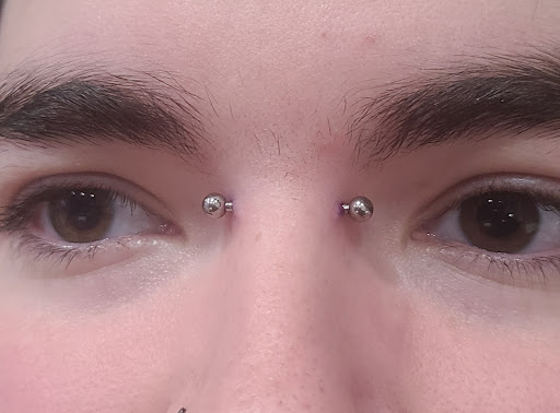 Explore red ink tattoo ideas for guys, creative tattoo ideas in Toledo, available at Needle Masters Tattoo Studio