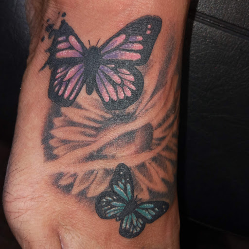 Explore dandelion tattoo ideas, creative tattoo ideas in Angola, available at Hoodlum Ink