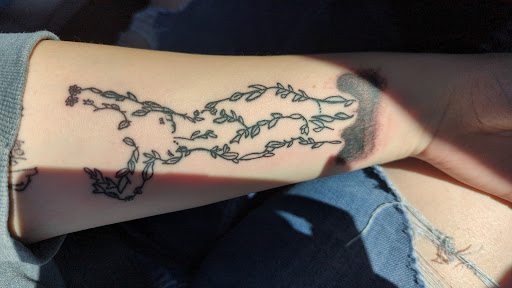 Explore red string tattoo ideas, creative tattoo ideas in Cary, available at Apocalypse Girl Tattoos