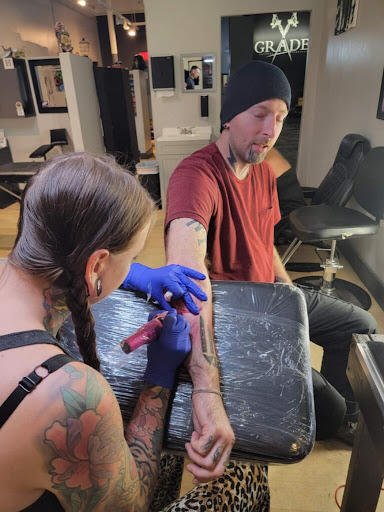 Explore calligraphy tattoo ideas, creative tattoo ideas in Fort Wayne, available at Grade A Tattoos and Body Piercing