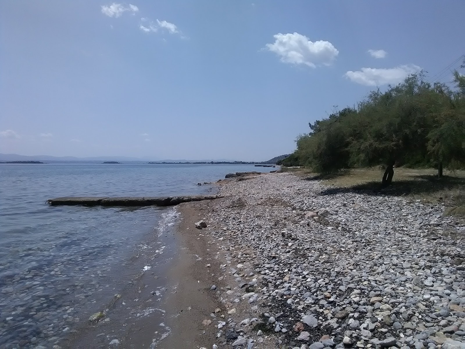 Photo of Magoula beach with green pure water surface