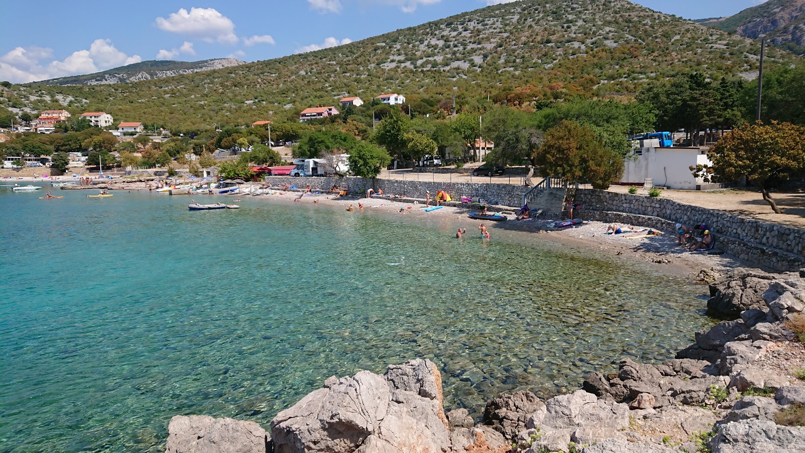Photo of Sibinj Krmpotski with turquoise pure water surface