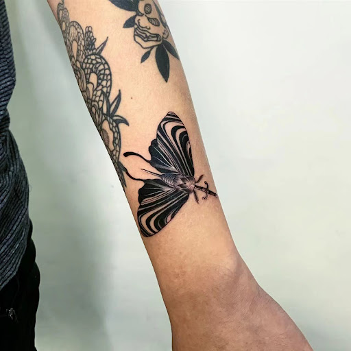 Explore wrap around wrist tattoo ideas, creative tattoo ideas in Orange, available at Baron Art Tattoo