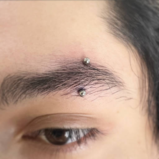 Explore cool face tattoos ideas, creative tattoo ideas in Orange, available at Baron Art Tattoo