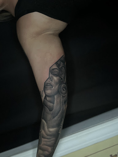 Explore lower back cover up tattoo ideas, creative tattoo ideas in Cadillac, available at Limitless Ink Tattoo Studio