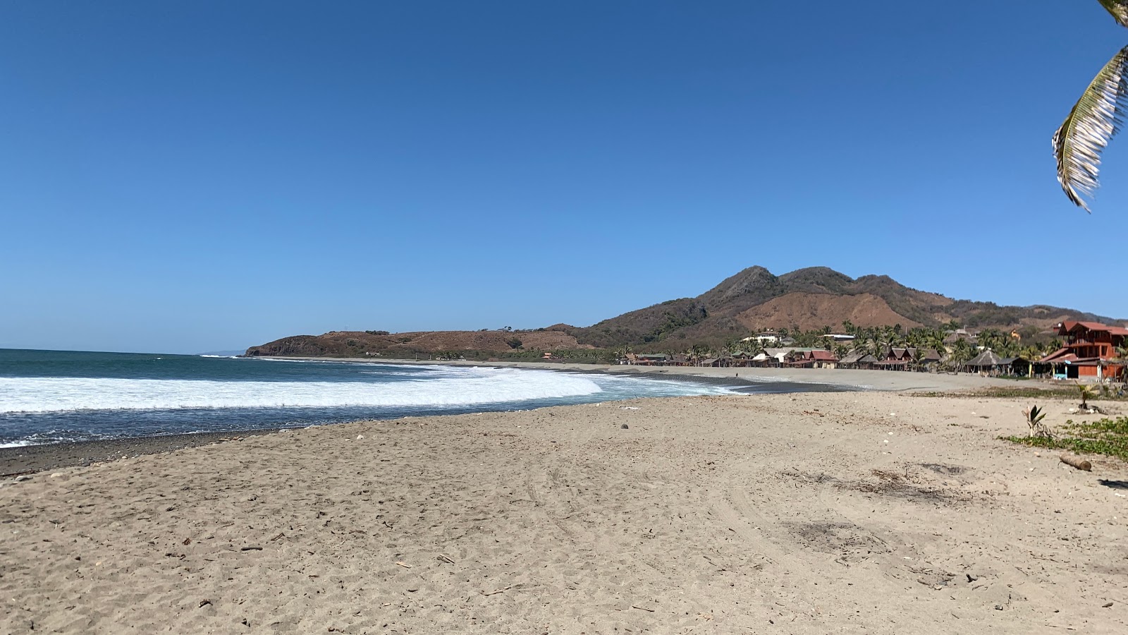 Photo de Playa Nexpa avec sable brun de surface