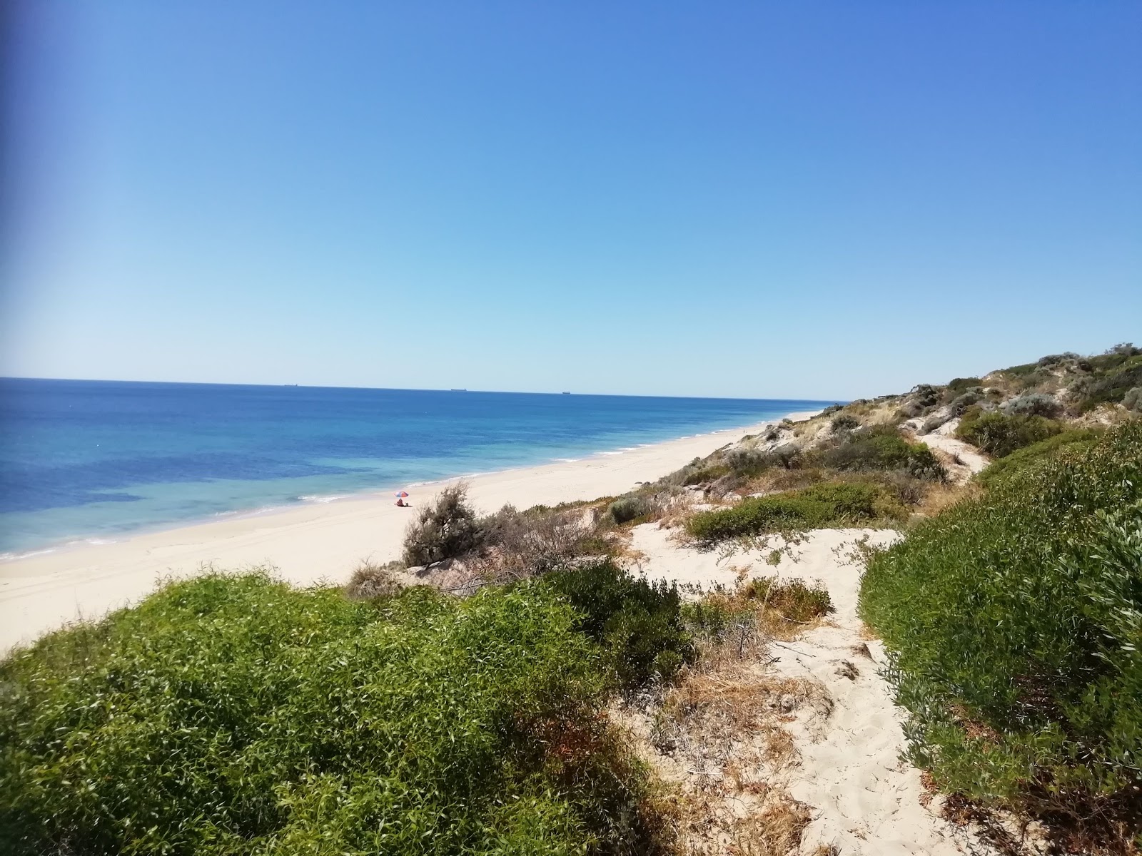 Foto van Mindalong Beach met beige zand oppervlakte