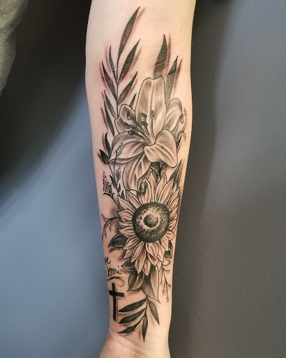 Explore dainty flower tattoo ideas, creative tattoo ideas in Bryan, available at Testament Tattoo