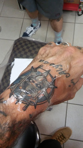 Explore nail technician tattoo ideas, creative tattoo ideas in Holly, available at Loyalty Tattoo Company