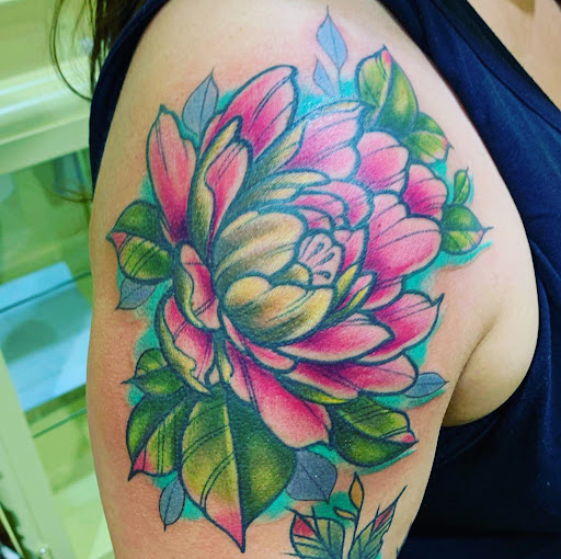 Find flower thigh tattoo ideas for your next unique tattoo in Marietta at The Queen Bee Tattoo and Piercing Parlour