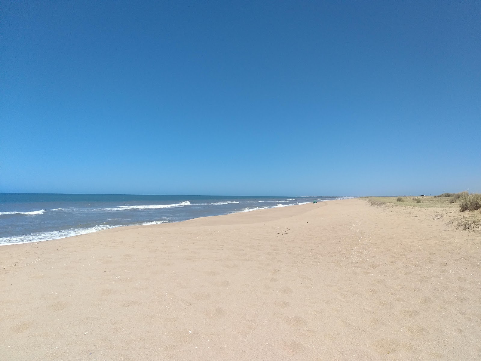Valokuva Escondida Beachista. pinnalla kirkas hiekka:n kanssa