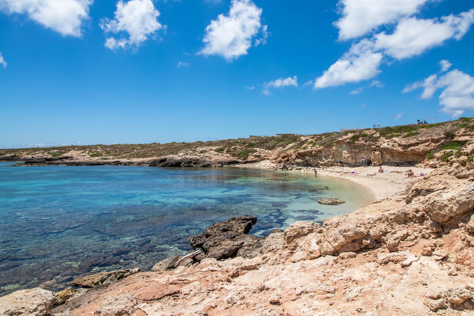Photo of Cala Spugne with brown sand surface