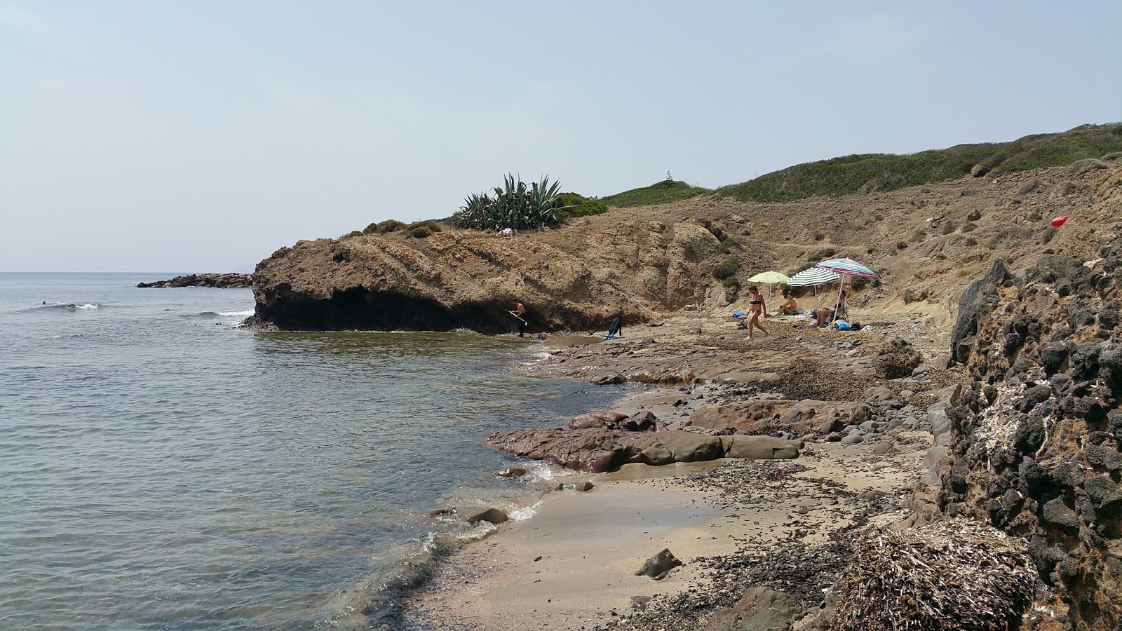 Foto av Spiaggia di Capo Sperone med blå rent vatten yta
