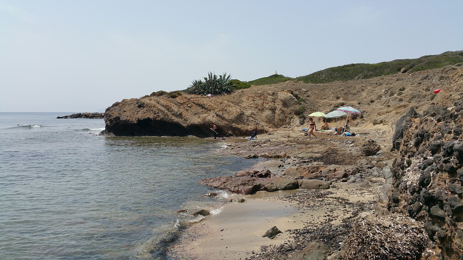 Capo Sperone Beach'in fotoğrafı düz bir kıyı şeridi ile birlikte