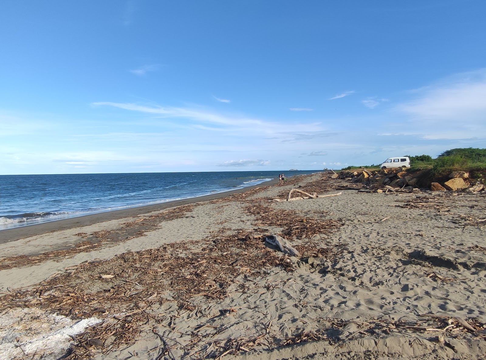 Foto van Monagre Beach met bruin zand oppervlakte