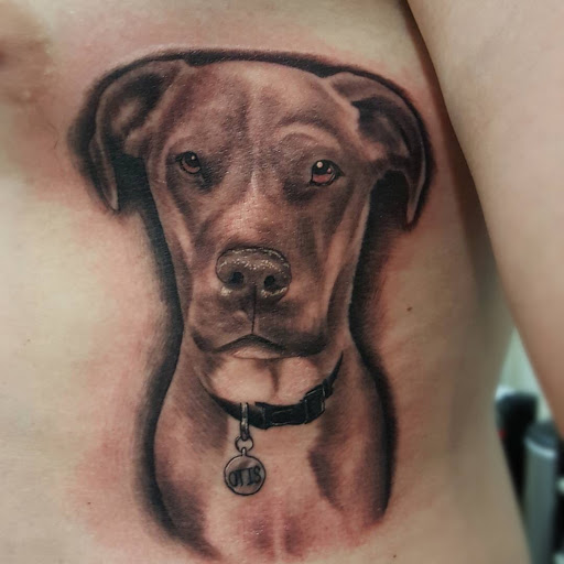 Explore dog tattoo ideas for guys, creative tattoo ideas in Peoria, available at Iron Key Tattoo Studio Inc.