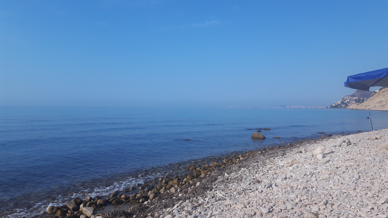 Foto di Playa Carritxal con una superficie del ciottoli grigi