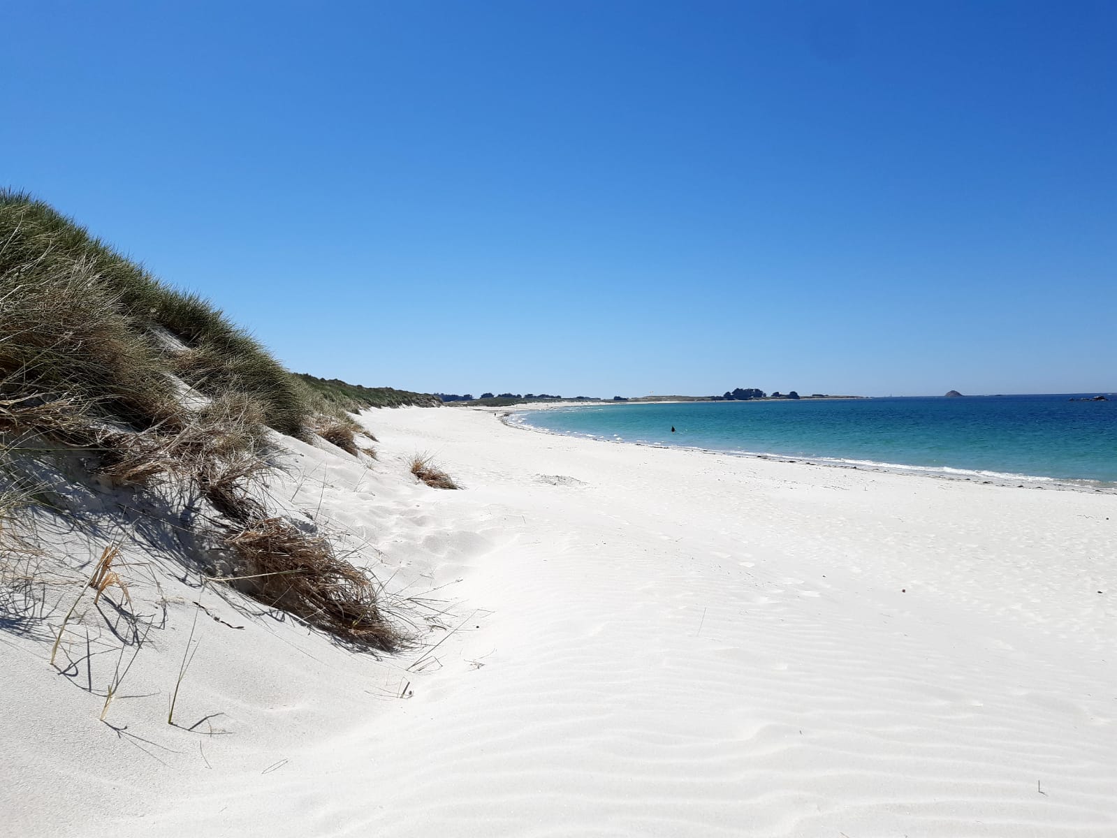 Foto di Plage des Trois Moutons con una superficie del sabbia bianca