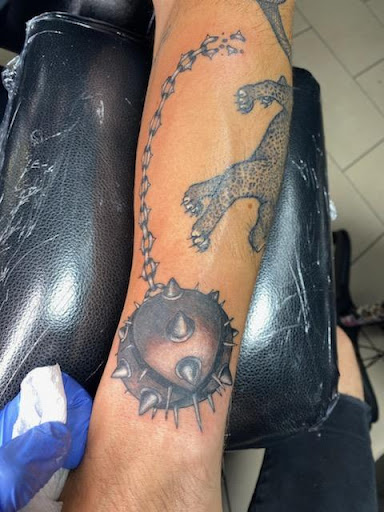 Explore bicep tattoo ideas for guys, creative tattoo ideas in Sarasota, available at SEVEN SINS Tattoo Studio