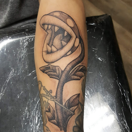 Explore leg tattoo ideas for men, creative tattoo ideas in Fresno, available at Happy Client Tattoo