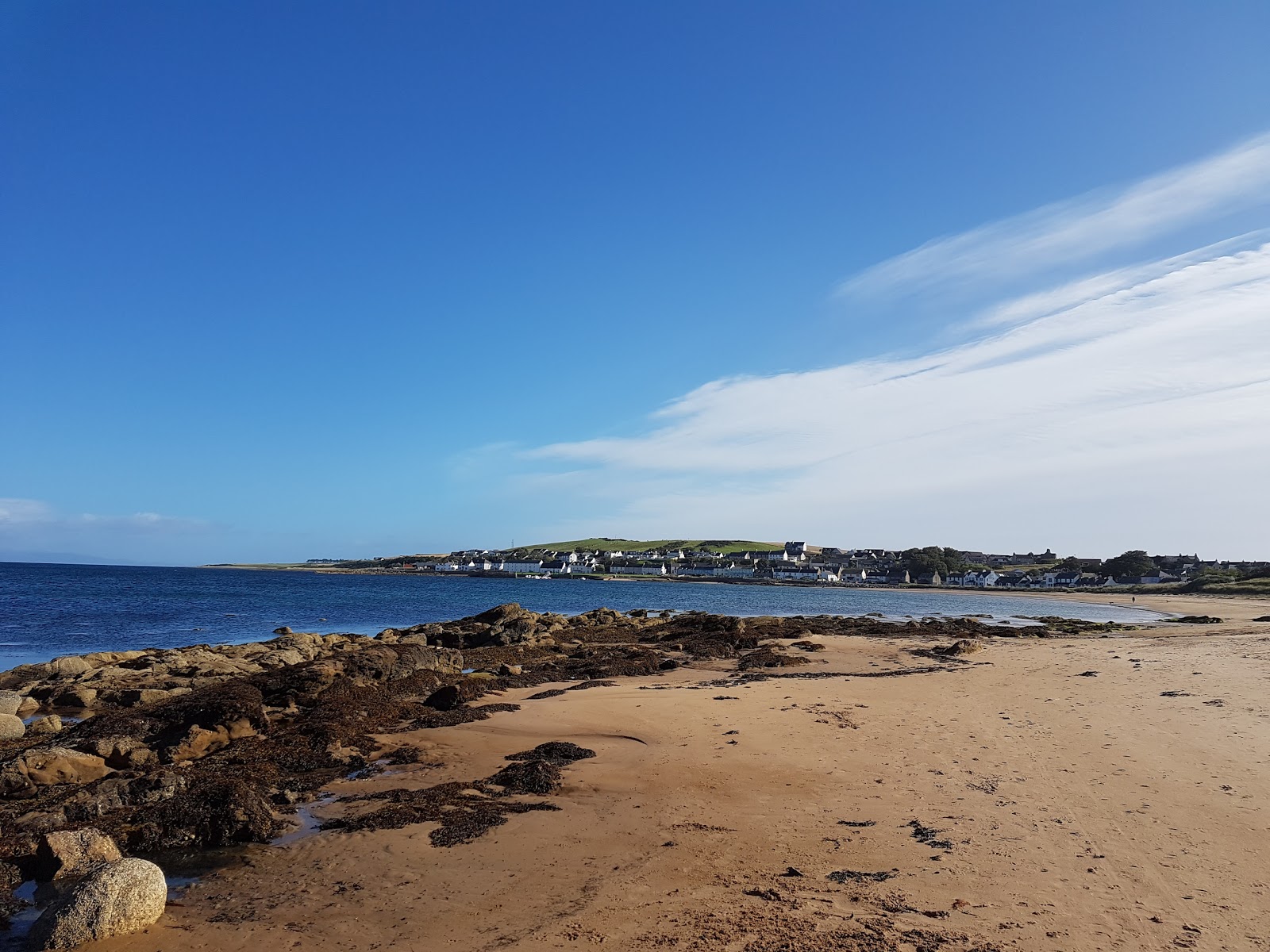 Photo of Portmahomack Beach with turquoise pure water surface