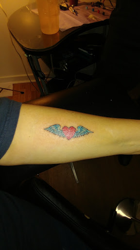 Explore skull hand tattoo ideas, creative tattoo ideas in Anniston, available at Artistic Addictions