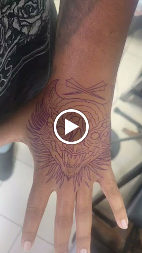Explore hand tattoo idea, creative tattoo ideas in Sarasota, available at SEVEN SINS Tattoo Studio