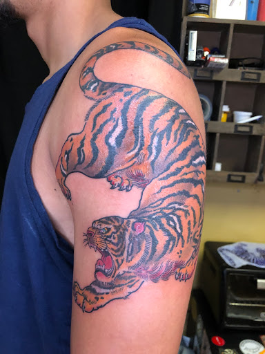 Explore tattoo ideas for new dads, creative tattoo ideas in Miami, available at Almost Famous Tattoo Parlour