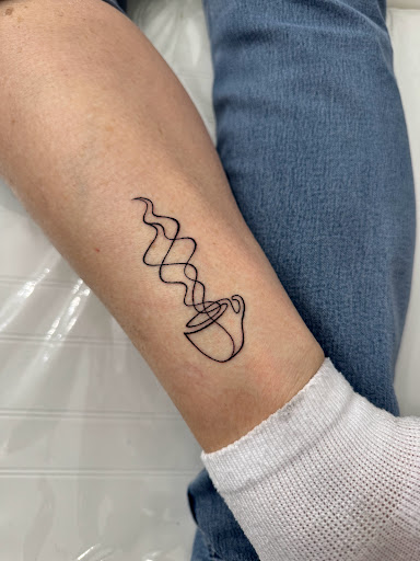 Explore dark skin male black skin tattoo ideas, creative tattoo ideas in Logan, available at The White Wasp Tattoo Studio
