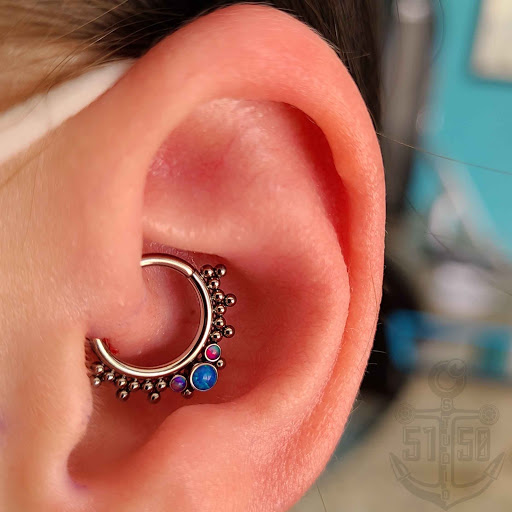 Find tattoo between breast ideas for your next unique tattoo in Kearney at Studio 5150 Piercing & Fine Jewelry