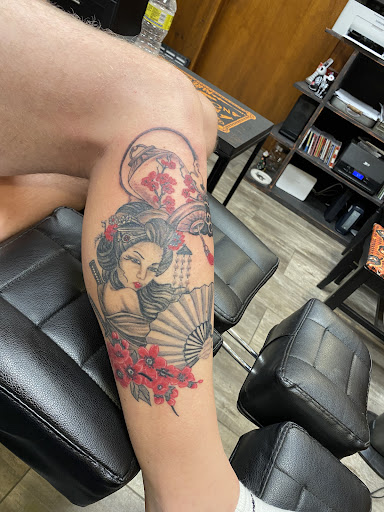 Explore fist bump tattoo ideas, creative tattoo ideas in Greenfield, available at Black Cat Tattoo, LLC