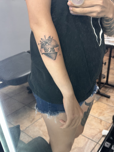 Explore grinch tattoo ideas, creative tattoo ideas in Baton Rouge, available at Black Torch Tattoo