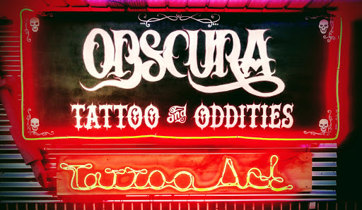Explore ribbon tattoo ideas, creative tattoo ideas in Muncie, available at Obscura Tattoo shop and Oddity Collective