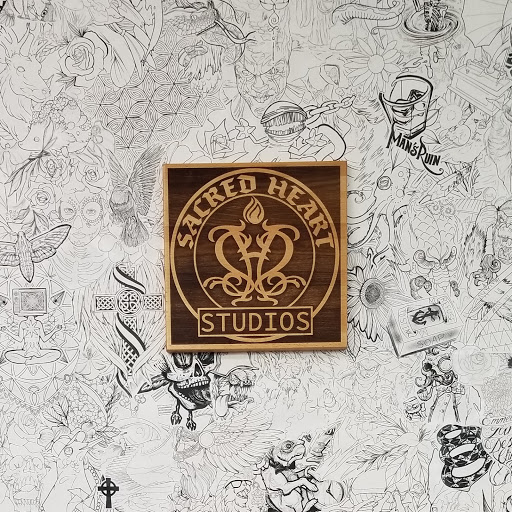 Explore mens thigh tattoo ideas, creative tattoo ideas in Rochester, available at Sacred Heart Studios