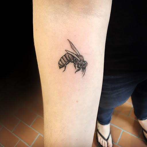 Explore apple tattoo ideas, creative tattoo ideas in Peoria, available at Freedom Ink Tattoos