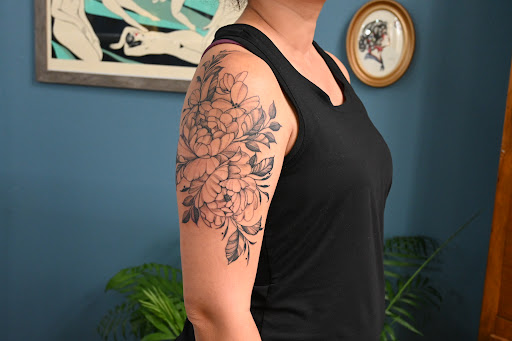 Explore half sleeve flower tattoo ideas, creative tattoo ideas in Ironwood, available at Iron Ink Tattoos