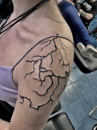 Explore rose hand tattoo ideas, creative tattoo ideas in Aurora, available at Ronin Tattoo Studio INC