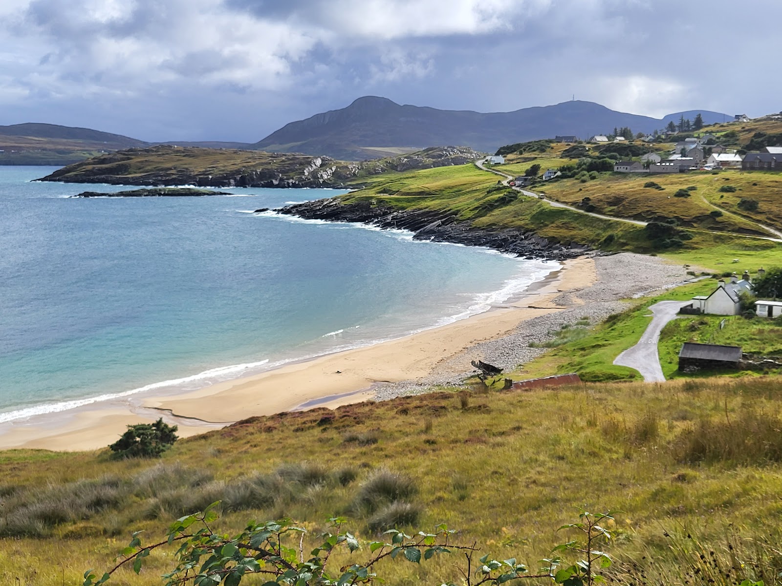 Photo of Talmine Bay with light sand &  pebble surface