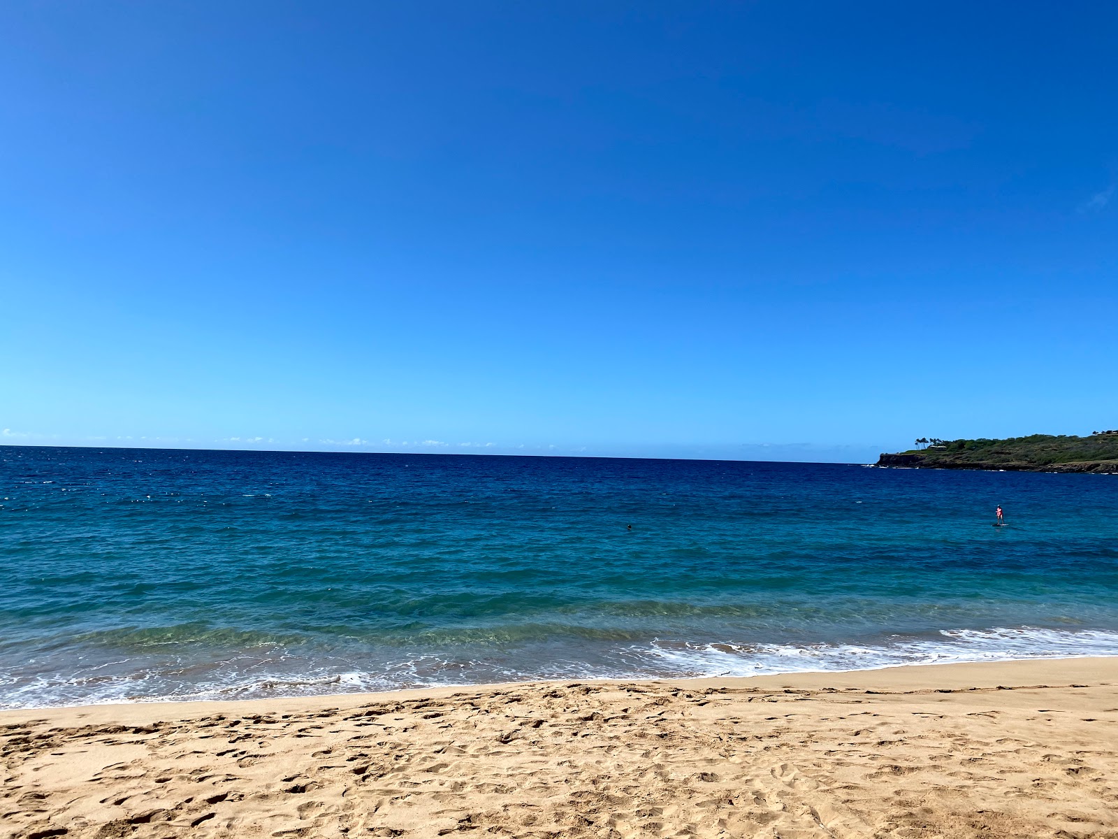 Foto af Hulopo'e Beach bakket op af klipperne