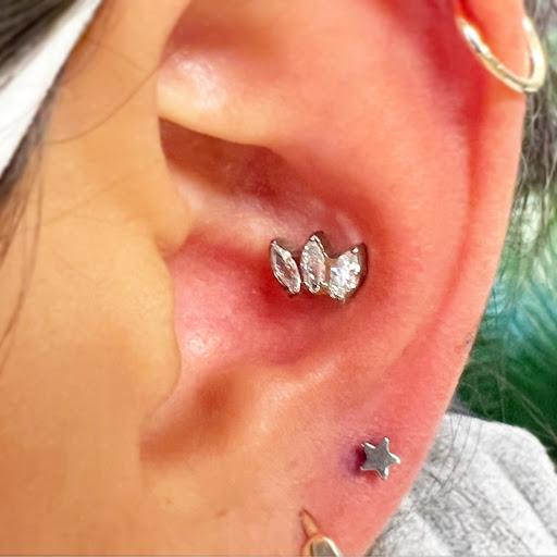 Explore inside ear tattoos ideas, creative tattoo ideas in Orange, available at Baron Art Tattoo