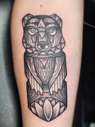 Find alpha and omega tattoo ideas for your next unique tattoo in White River Junction at Standard Company Tattoo